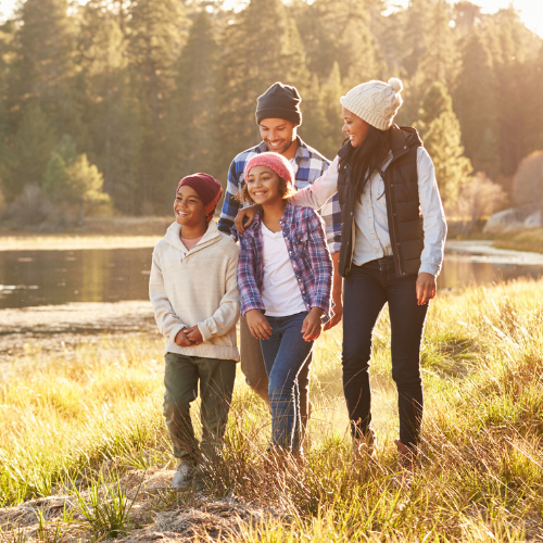 family walking by the lake