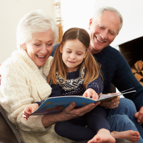 Grandparents reading to grandchild